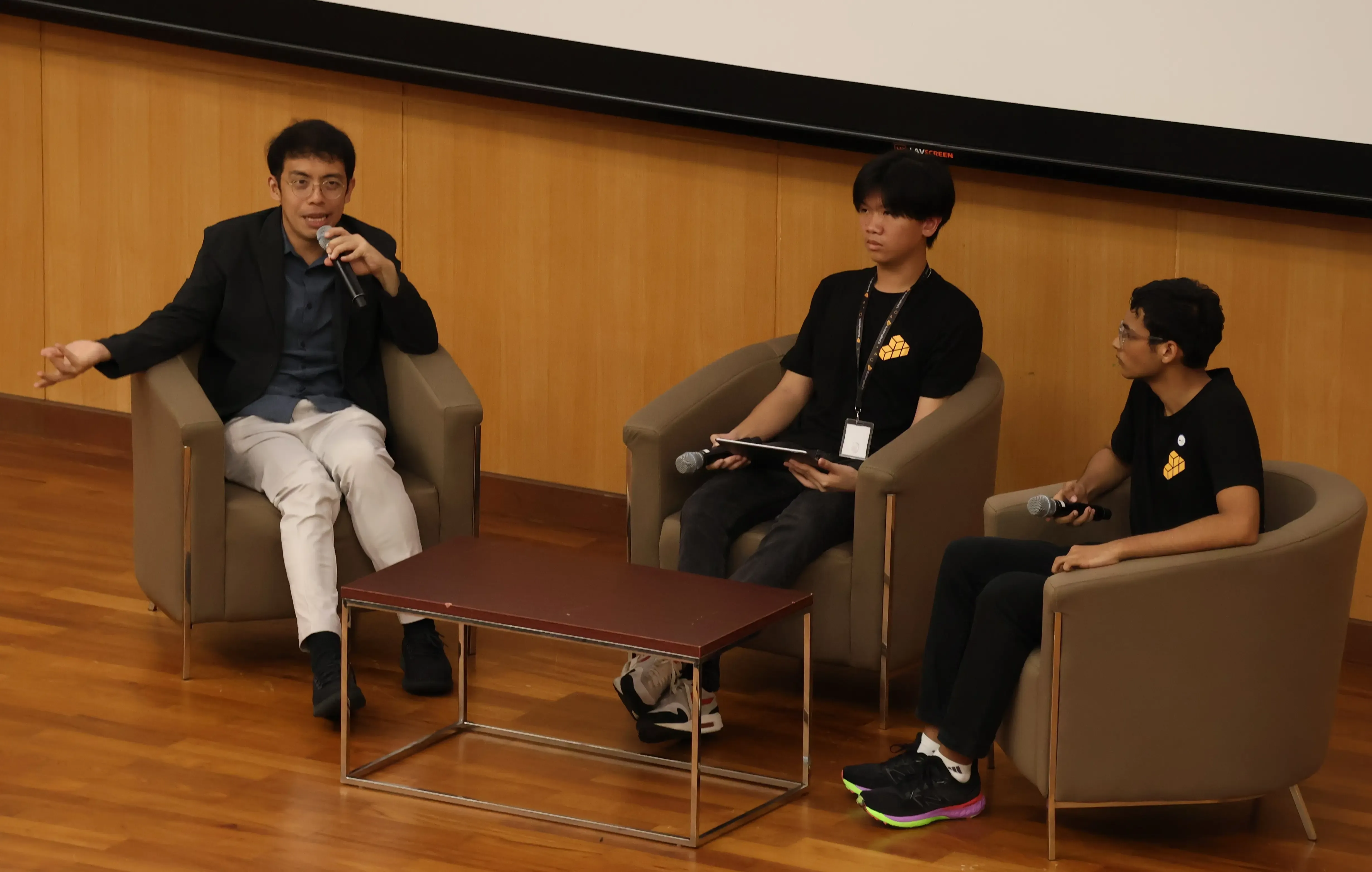 Two organisers speaking at a FOSSASIA event